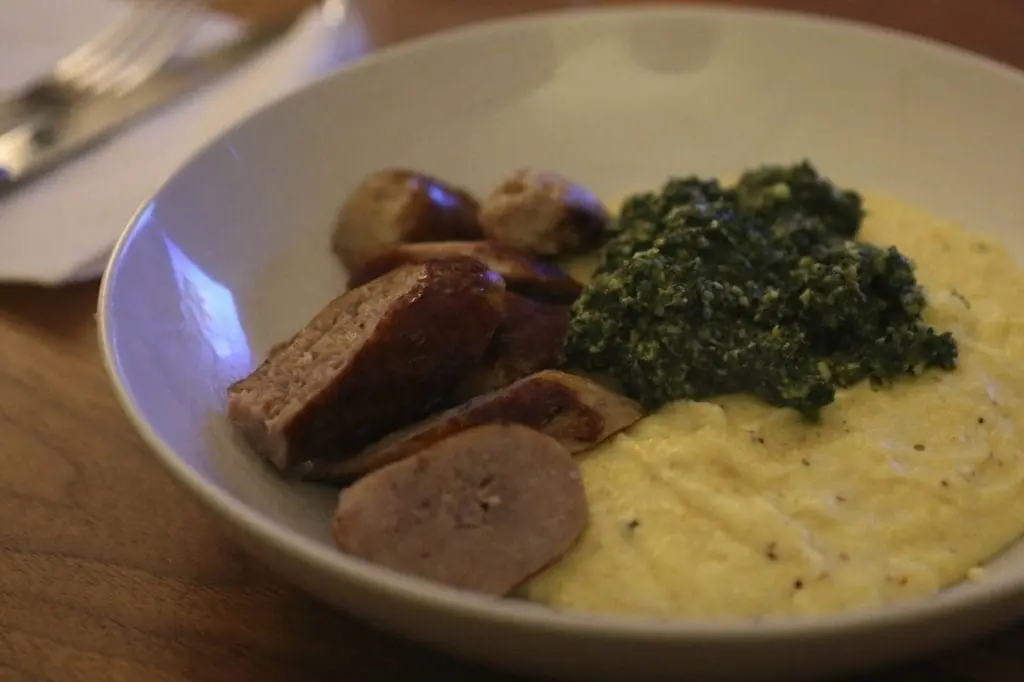 Sausage, creamy polenta, kale walnut pesto