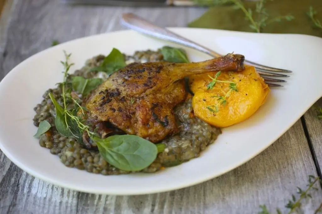 Crispy Spiced Duck Legs with Honey and Thyme Roasted Peaches.