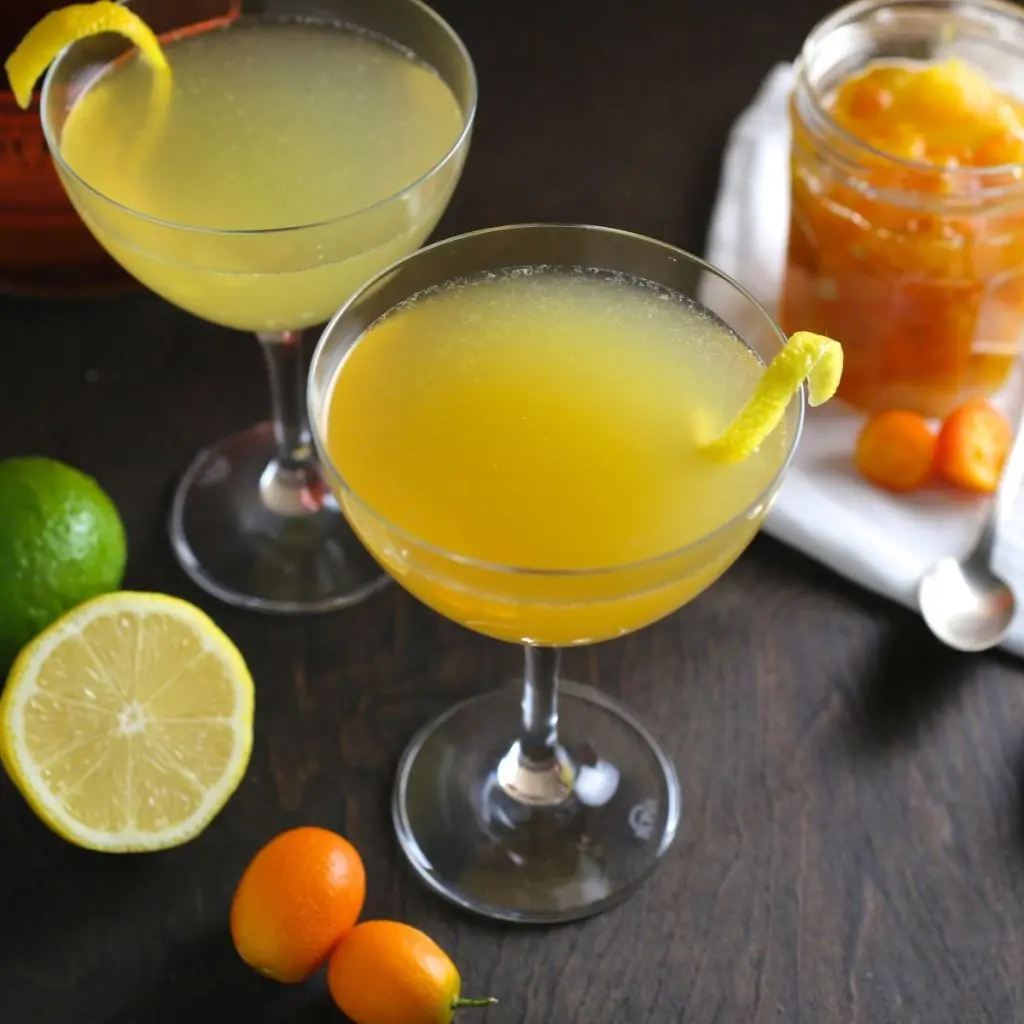 Cocktail glasses with a bright yellow citrus drink