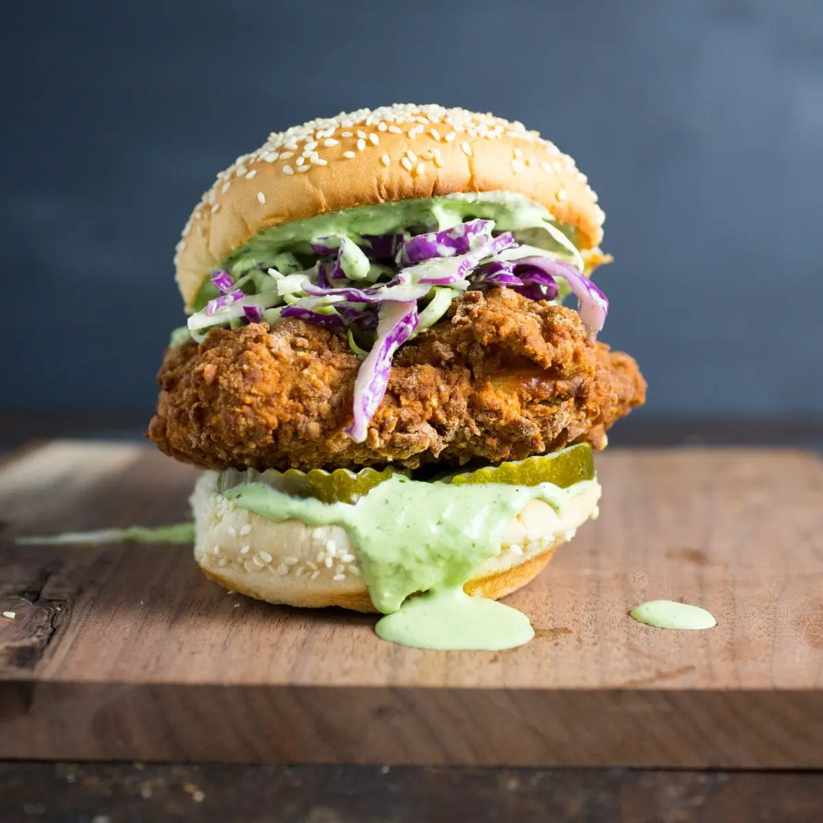 A fried chicken sandwich on a board