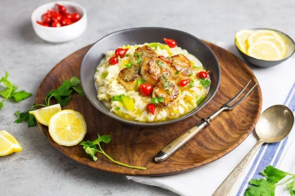 A bowl of scallops on risotto