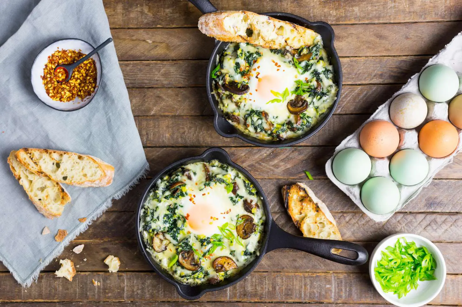 Baked Eggs with Creamy Kale and Chard with Garlic Butter Toasts