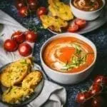 A bowl of tomato soup with toast