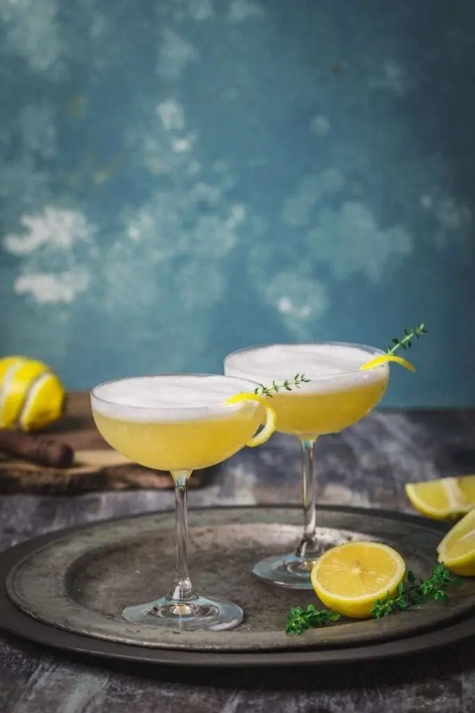 Two cocktail glasses filled with a frothy cocktail