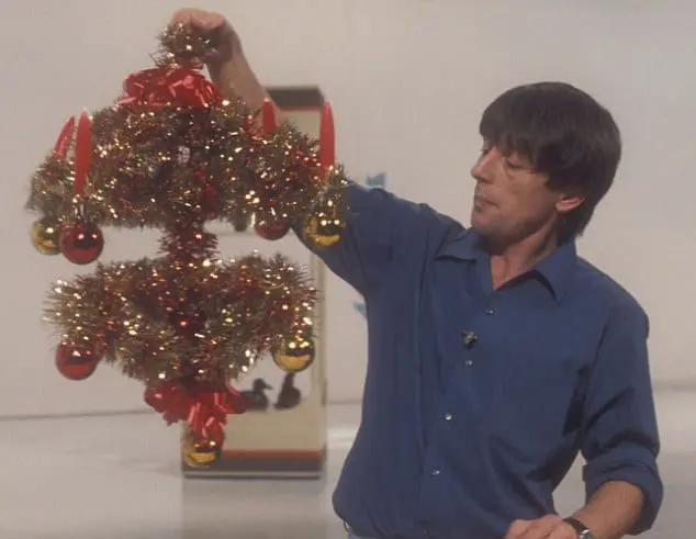 John Noakes in a studio with a homemade Christmas advent candle