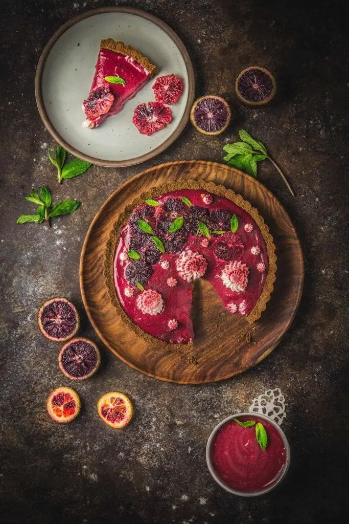 A red curd tart sliced on plates