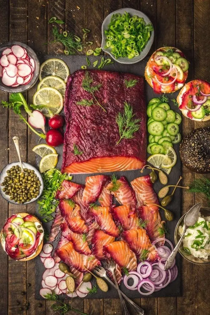 Cured salmon with a beet-red skin, sliced thin and surrounded by sliced veggies