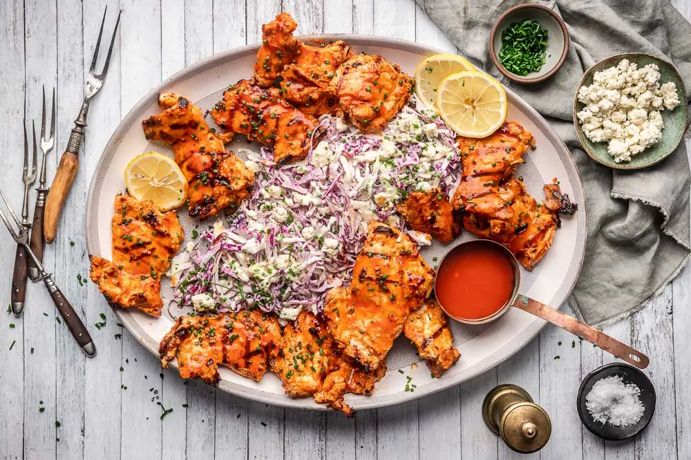 Grilled Buffalo Chicken Thighs with Blue Cheese Slaw