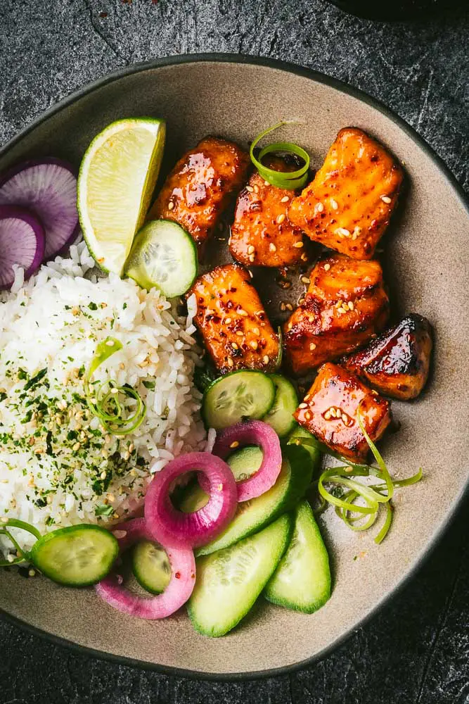 Air fryer salmon bites in a bowl with rice and vegetables