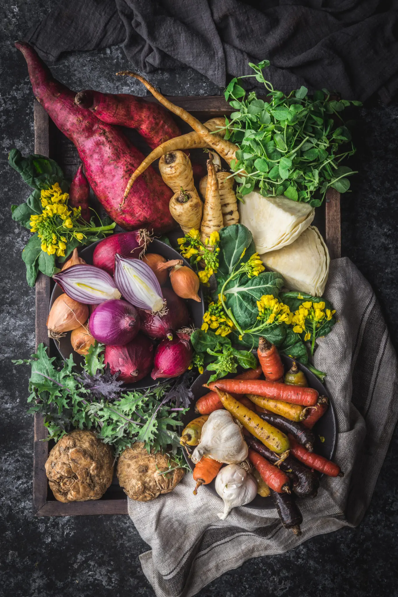 Wooden box filled with fresh, raw vegetables