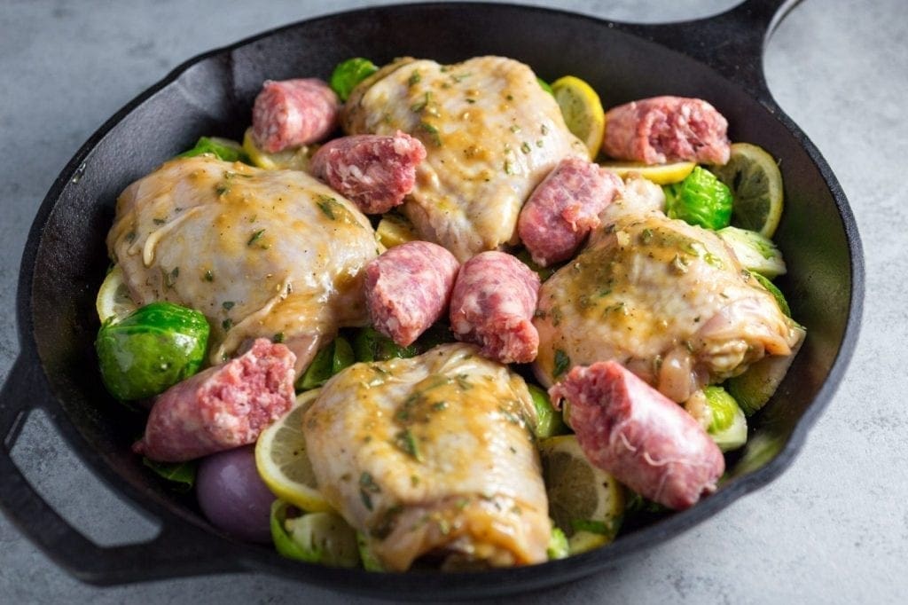 Layer the chicken and sausages on top