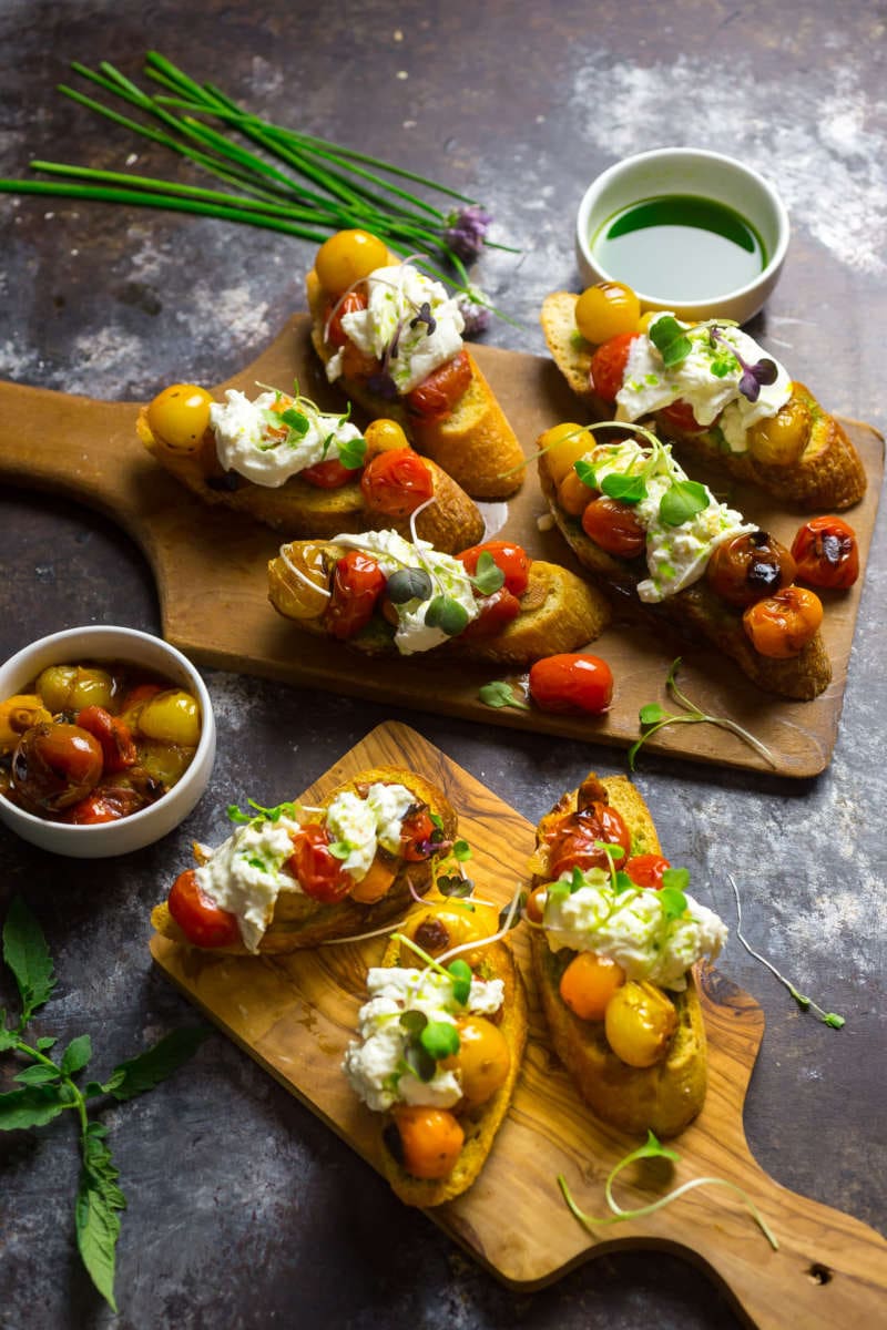 Crostini With Blistered Cherry Tomatoes, Burrata And Chive Oil