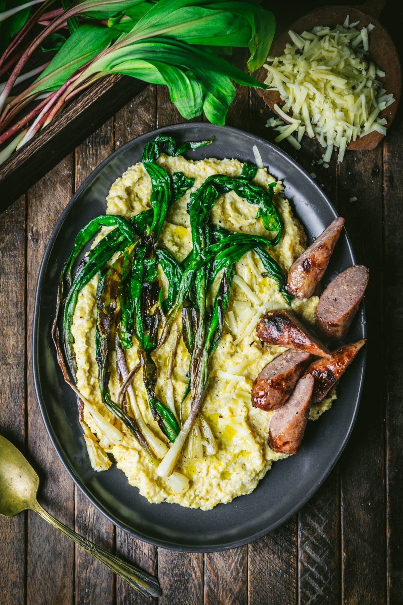 Creamy Cheddar Polenta with Sausage and Charred Ramps