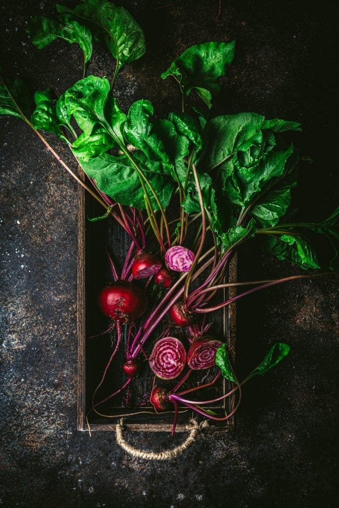 A bunch of beets in a wooden box
