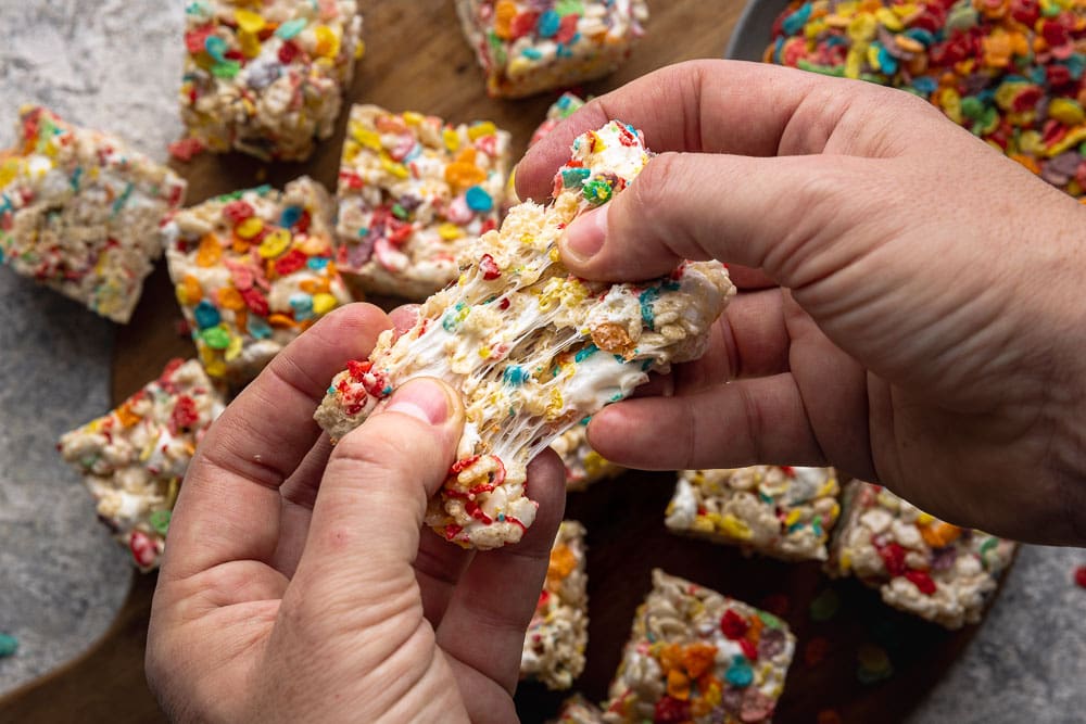 Hands pulling apart a marshmallow square
